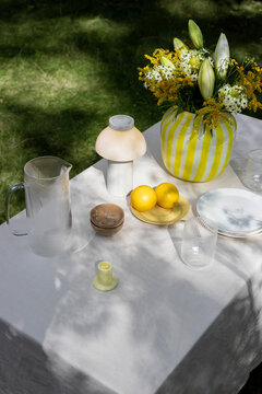 Table  for outdoor picnic with stylish tableware and decor items.