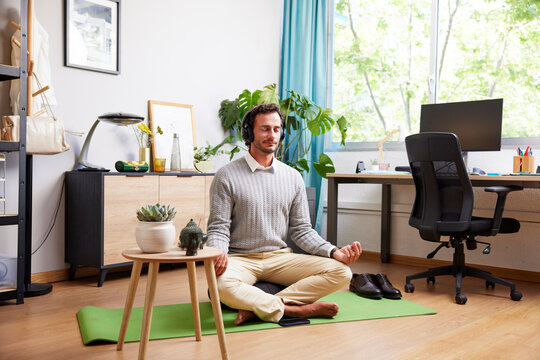 Male manager meditating during break from work