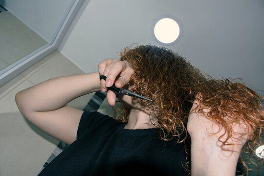 Woman cutting her hair