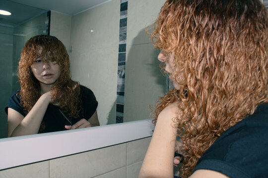Woman cutting her hair