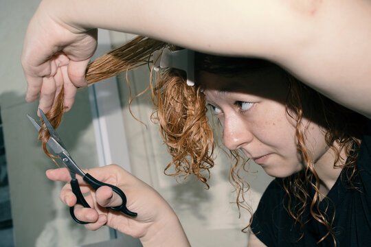 Woman cutting her hair