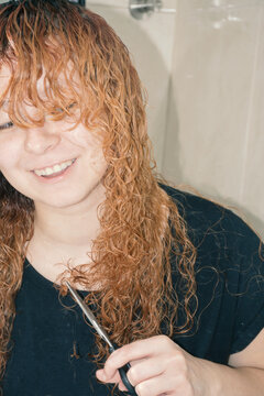 Woman cutting her hair