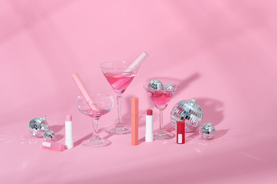 Make up products prsented on pink podiums on pink pastel background.