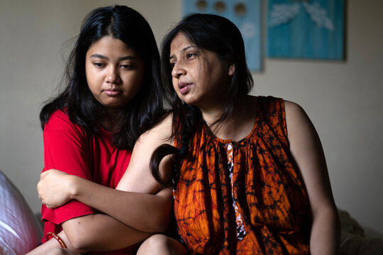 Mother and daughter interacting affectionately inside home 