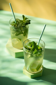 Classic rum mojito cocktail against green background