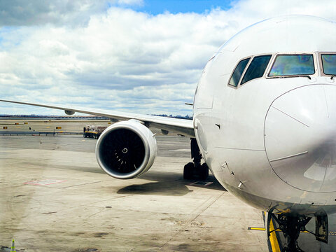 Airplane with wing and engine at airport