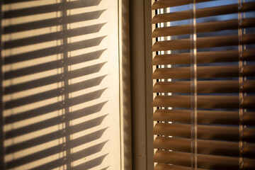 Blinds on the window. Light through the blinds. Window in the morning.