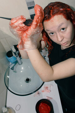 Woman dyeing her hair red