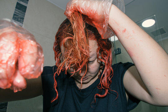 Woman dyeing her hair red