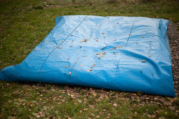 Blue awning. Rolled up awning in nature. Rain protection.