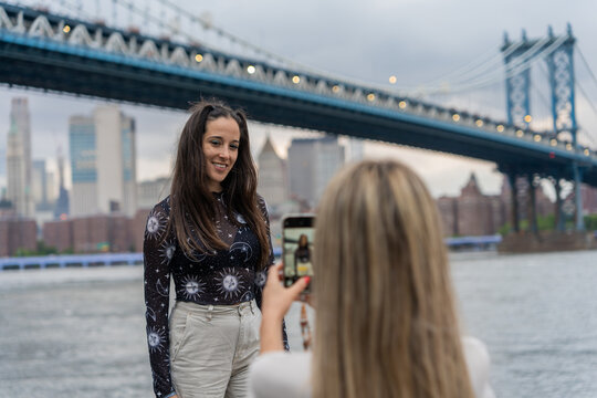 Two Tourist Girls Taking Photos In Brooklyn, New York.