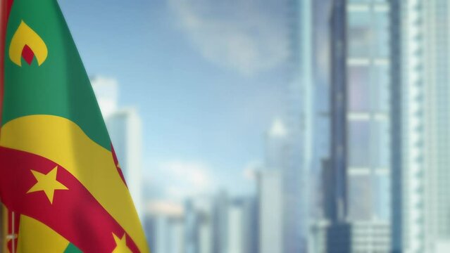 hanging Grenada flag on city bg with blue sky