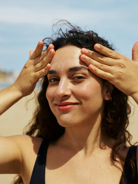 Seaside Carefree: Applying Sunscreen at the Beach        