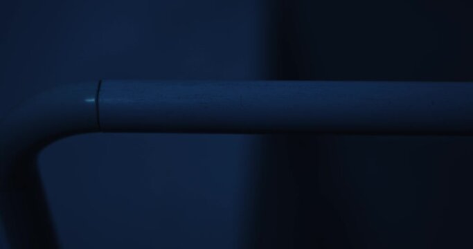 Close up of shower curtain rings opening in a dark bathroom