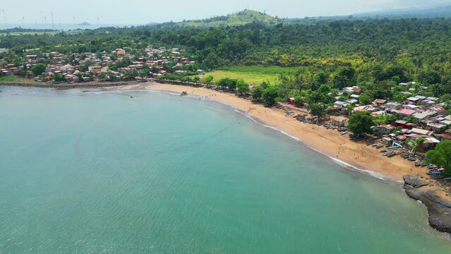 Aerial view from Melão beach and village with the anchored boats at sand, São Tome,Africa