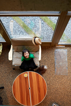 Asian little girl, playing in the living room. Overhead angle