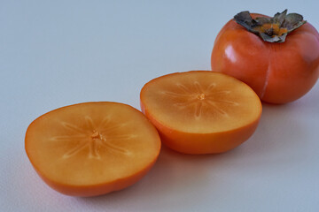 Fresh persimmon fruit on white background. Selective focus.