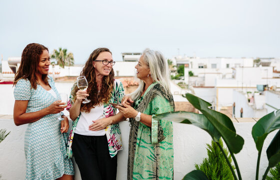 Three friends drinking wine together.