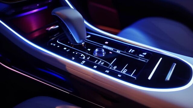 The gear shift of the car displays a sleek and modern white neon light giving off a sleek and sophisticated aesthetic.