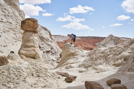 Man hiking in the Paria Rimrocks Toadstool Hoodoos 