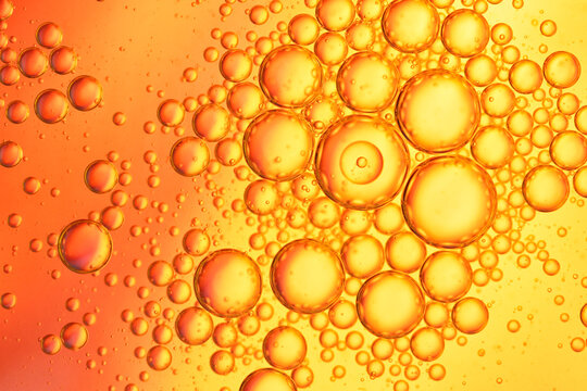 Red And Orange Oil Drops On Water Surface  