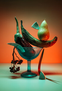 Art still life with eggplant, banana and pear.