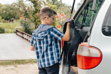 Teen Boy Throwing School Bag into Car, First day at school