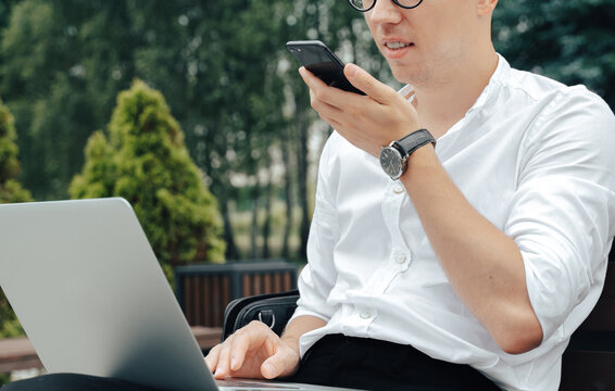 Businessman make phone call outdoor, record audio message using voice 