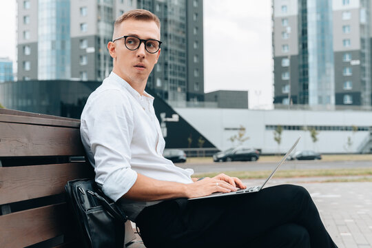 Confident millennial man working outdoors, contemplating solutions
