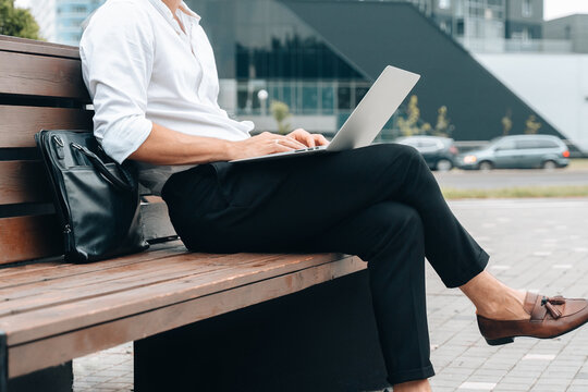 Crop close up of male real estate agent work distant typing on laptop
