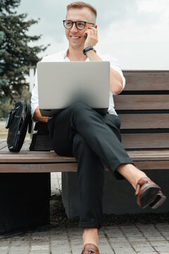 Millennial Man working online having phone call outdoor
