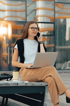 Modern professional millennial businesswoman having phone call 