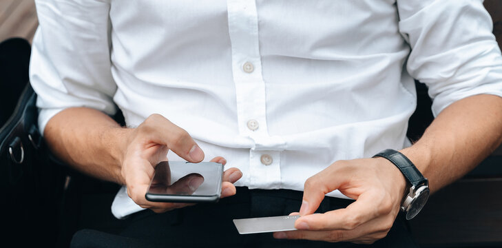plastic credit card in male hands making online payment