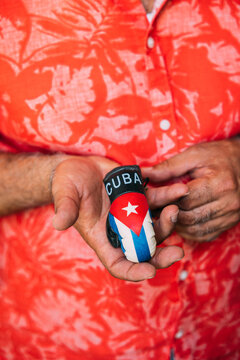 Crop mature man holding a small cuban boxing glove