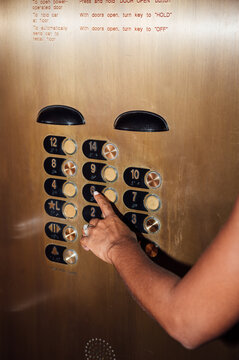 Going up, woman press button on the elevator