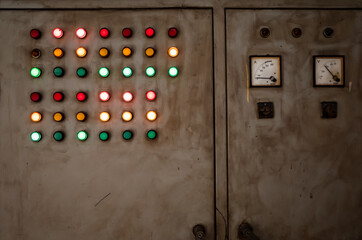 Old and rustic electrical control panel with red, green and yellow lights
