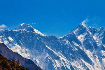 Mount Everest, Nuptse jagged ridge and Lhotse summit visible in this telephoto shot from Namche Bazaar in Khumbu, Nepal - obrazy, fototapety, plakaty
