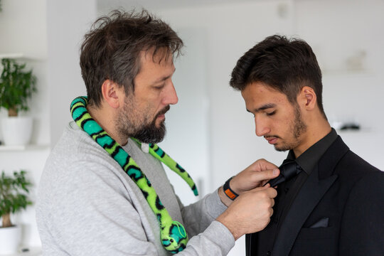Candid Shot of a Father Fixing his Son's Tie