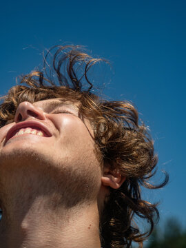 Young handsome guy with long hair smiling 