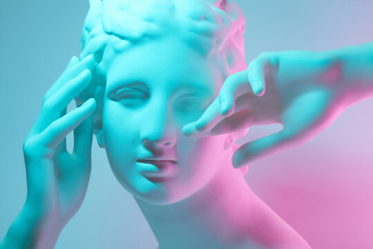 Gypsum woman statue with gesturing hands.