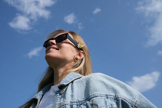 Smiling woman on a blue sky background 