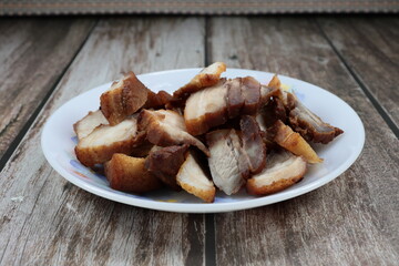 Roasted belly pork serving on the plate. Famous pork snack menu in Asian restaurant. 