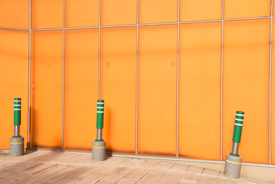 Green barricade in front of the orange building