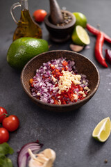 Cooking traditional salsa - sliced chopped ingredients in a wooden bowl
