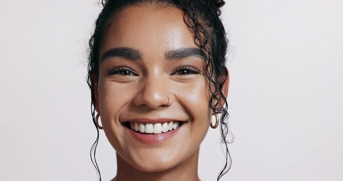 Portrait, smile and beauty for happy woman, natural skincare and in studio on white background. Makeup, healthy and aesthetic glow with curly hair, female model and cosmetic or spa salon for wellness