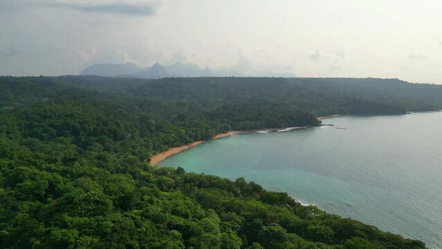 Aerial view of the magnificent and green coastline with stunning beaches from ilha do principe (prince island) Sao Tome,Africa.
Backwards drone shot