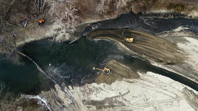 Aerial view of bulldozers and excavators working to divert the course of a river