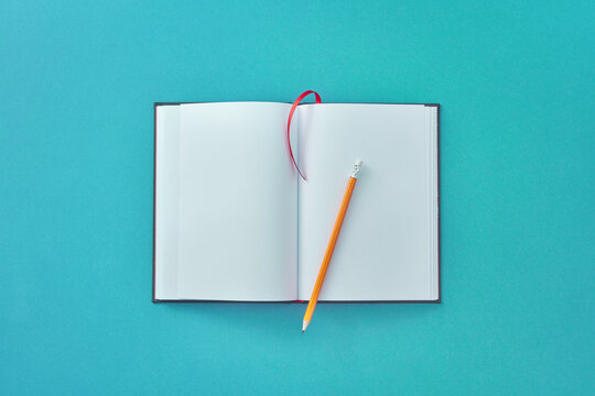 Top view of blank notebook with pencil.
