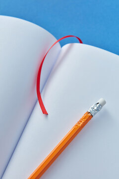 Close-up of empty notebook with pencil.