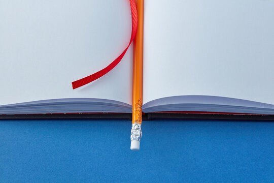 Close-up of pencil on blank book.